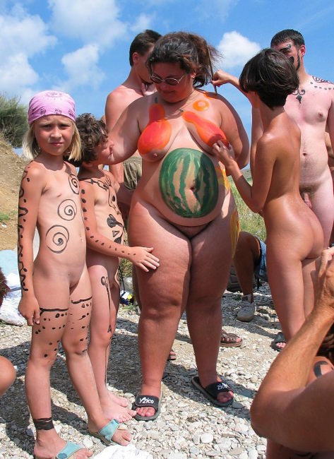 Nudists on a beach organized bodyart