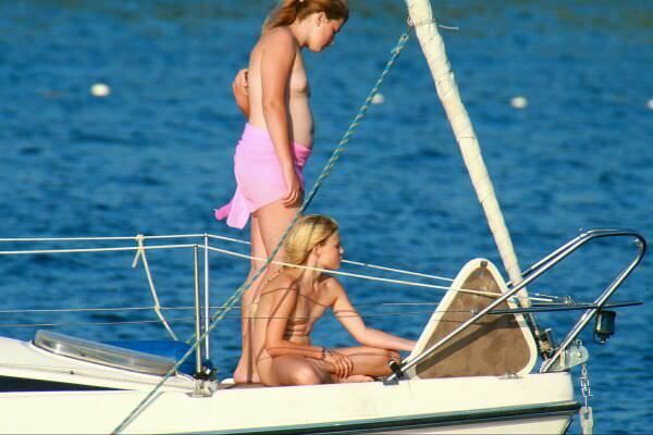 Photo of nudists by the boat