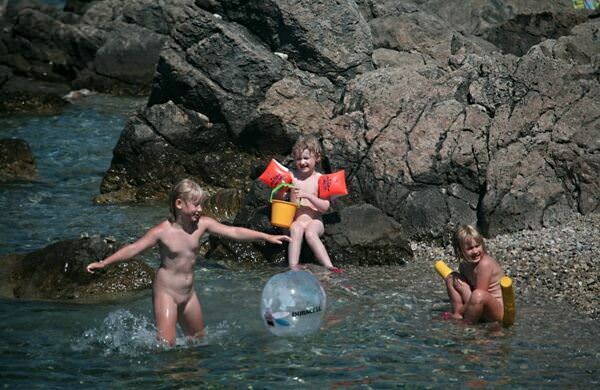 People are engaged in a nudism among rocks