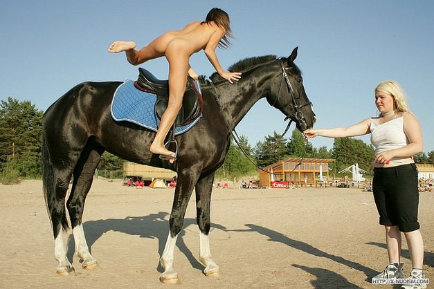 Young nudists learn to ride on horseback photo pure nudism